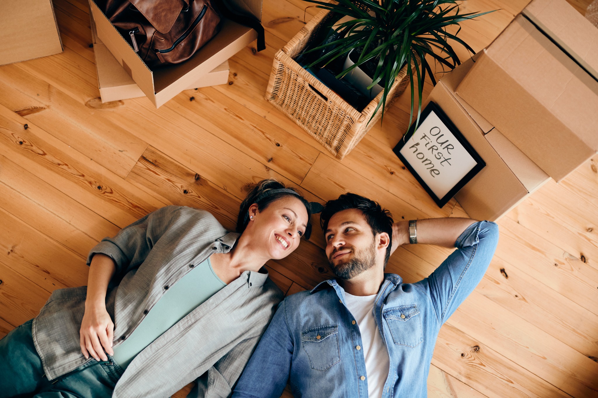Happy couple relaxing after moving into their first home